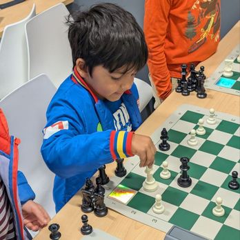 Kids playing chess at camp
